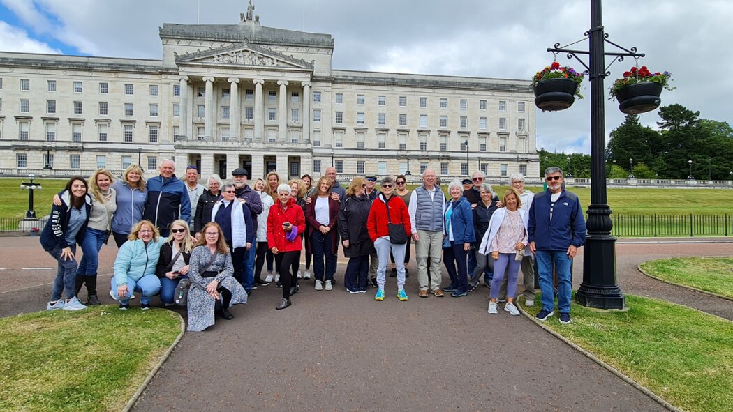 Small group of travelers near a coach in Ireland
